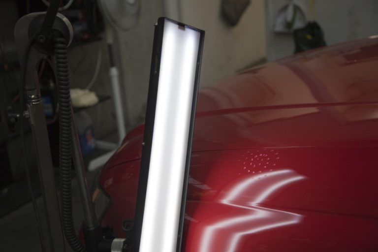 Lamp reflection across a red panel