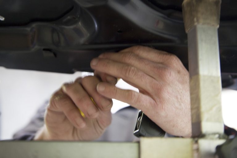 Hands at work under a panel