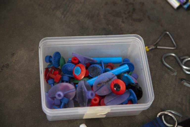 A box of glue pulling tabs in different shapes