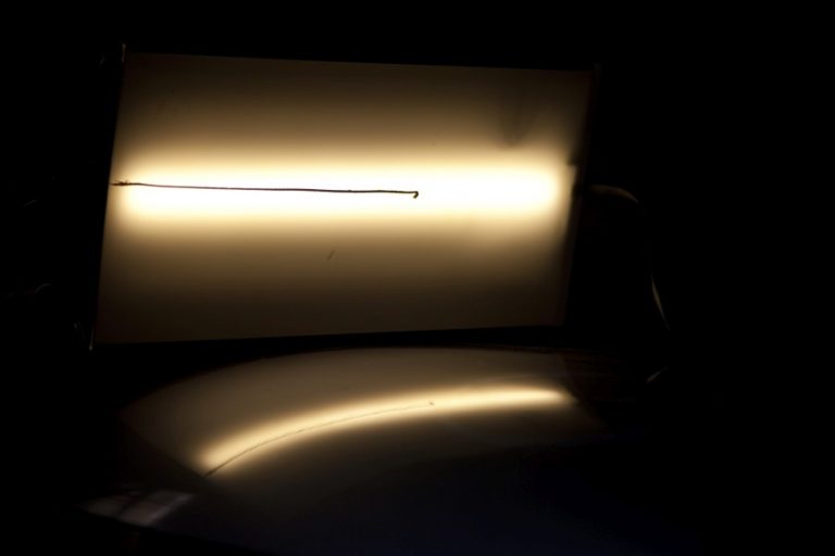 A reflected line shows the dent as a distortion