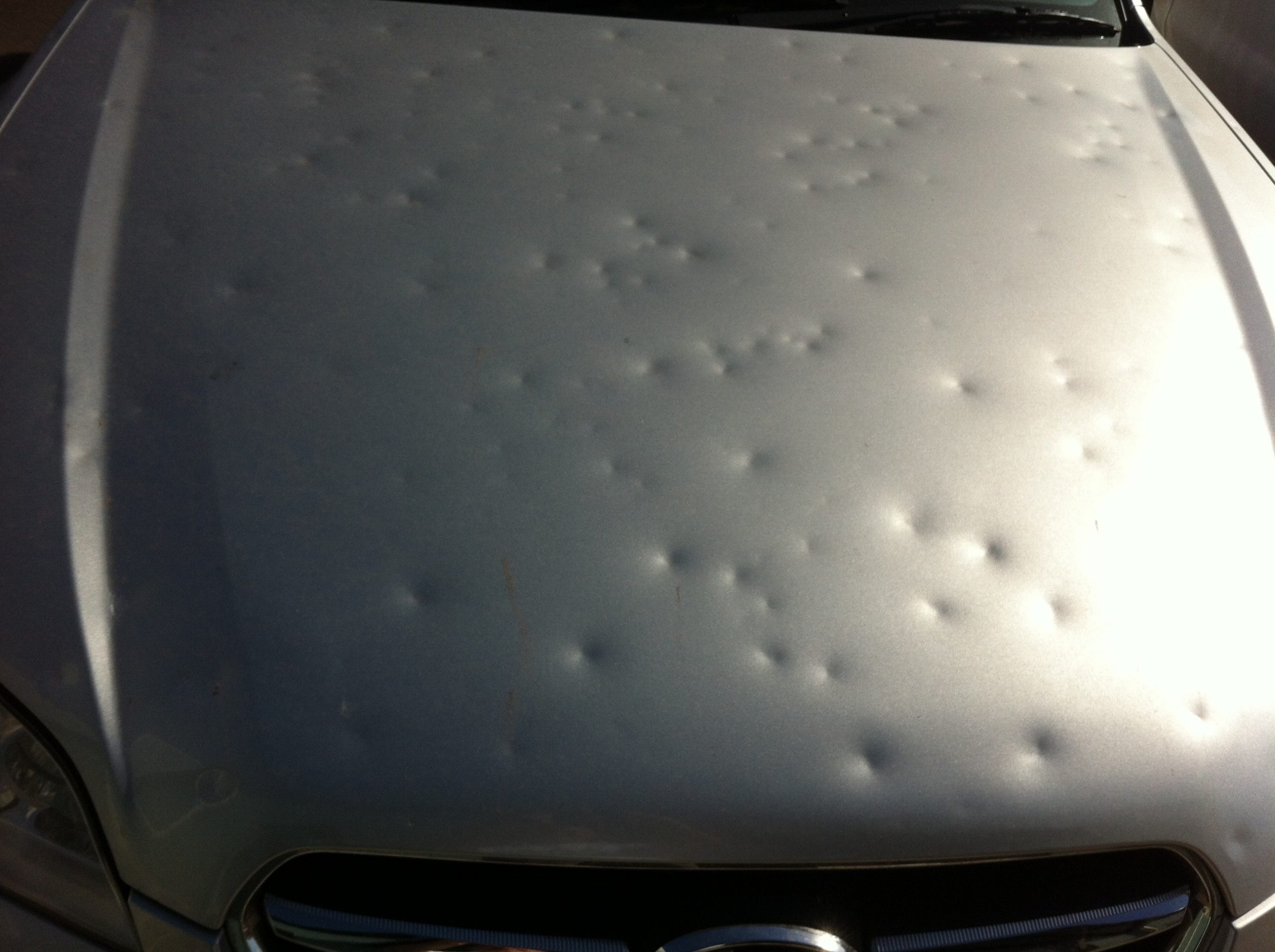 Hail dents on a bonnet